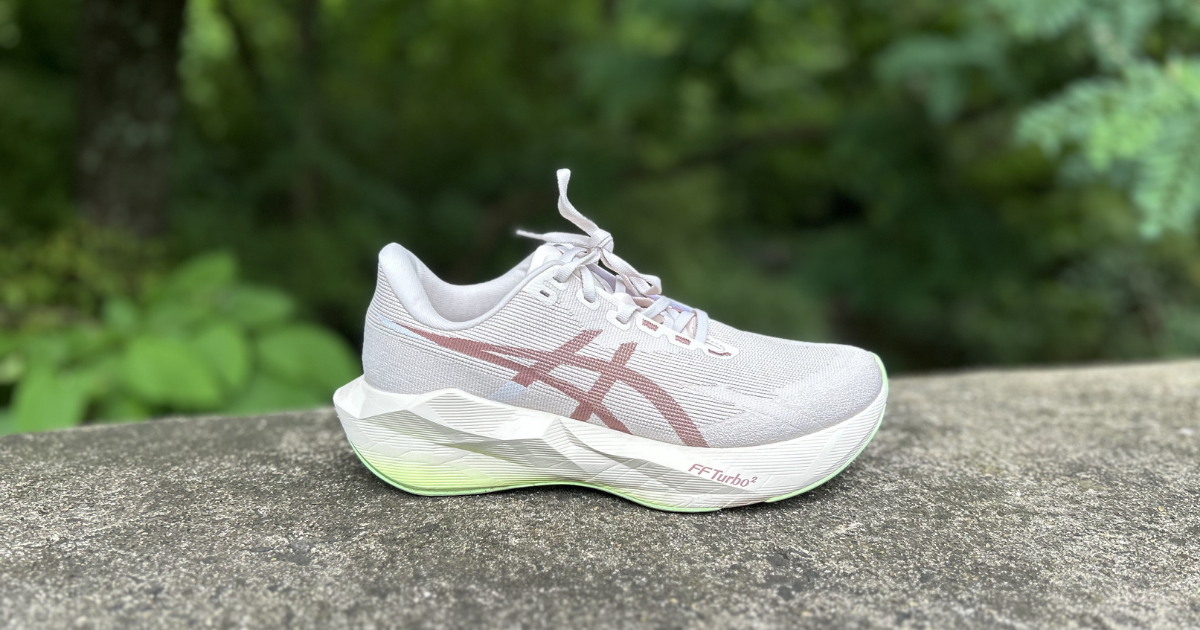 ASICS Novablast 6 side profile on a stone wall