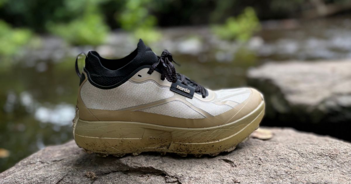 norda 055 trail shoe on a rock beside a creek