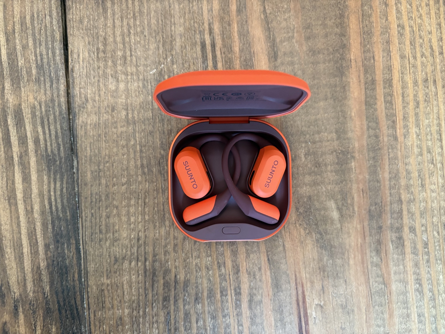 Suunto Spark earbuds, charging case, and Suunto watch
